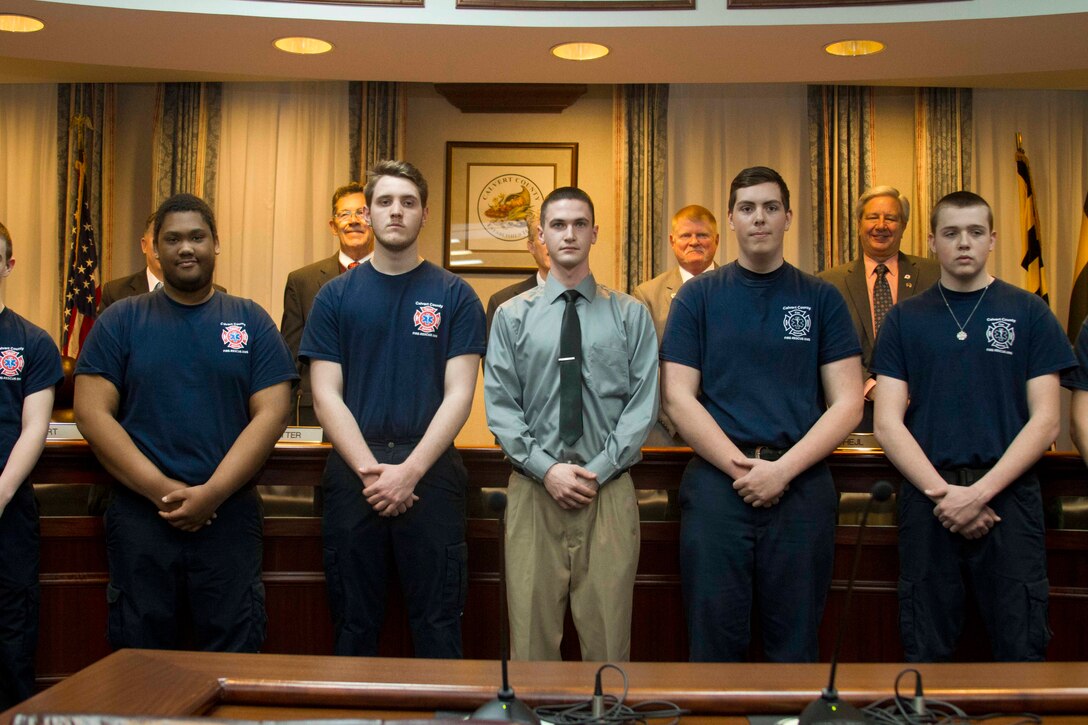 Matthew Shrawder, center, a firefighter with the Dunkirk Volunteer Fire Department, is recognized for his acts of heroism while rescuing a woman from a house fire by the Calvert County Board of Commissioners during their monthly meeting on March 24, 2015. (U.S. Marine Corps photo by Sgt. Bryan Nygaard/Released)