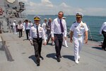 SINGAPORE (May 19, 2015) - Cmdr. Joseph Torres, commanding officer of the Arleigh Burke-class guided-missile destroyer USS Mustin (DDG 89), right, walks with Singapore Minister of Defence Dr. Ng Eng Hen aboard the ship during a tour. Mustin is participating in Singapore’s International Maritime Defence Exhibition (IMDEX) along with the littoral combat ship USS Fort Worth (LCS 3). 