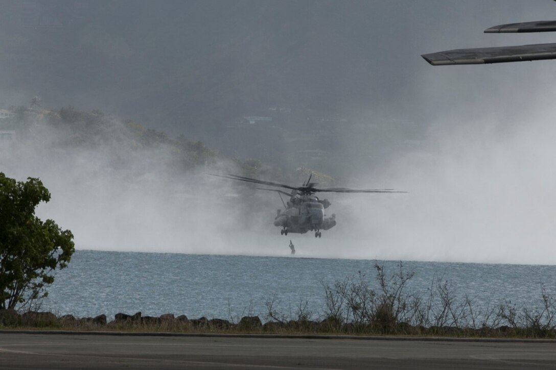 U.S. Marines with the 15th Marine Expeditionary Unit’s Maritime Raid Force helocast out of a CH-53 Super Stallion aboard Marine Corps Base Hawaii, May 14, 2015. These Marines practiced helocasting to ensure they are prepared for any type of mission. (U.S. Marine Corps photo by Cpl. Anna Albrecht/Released)