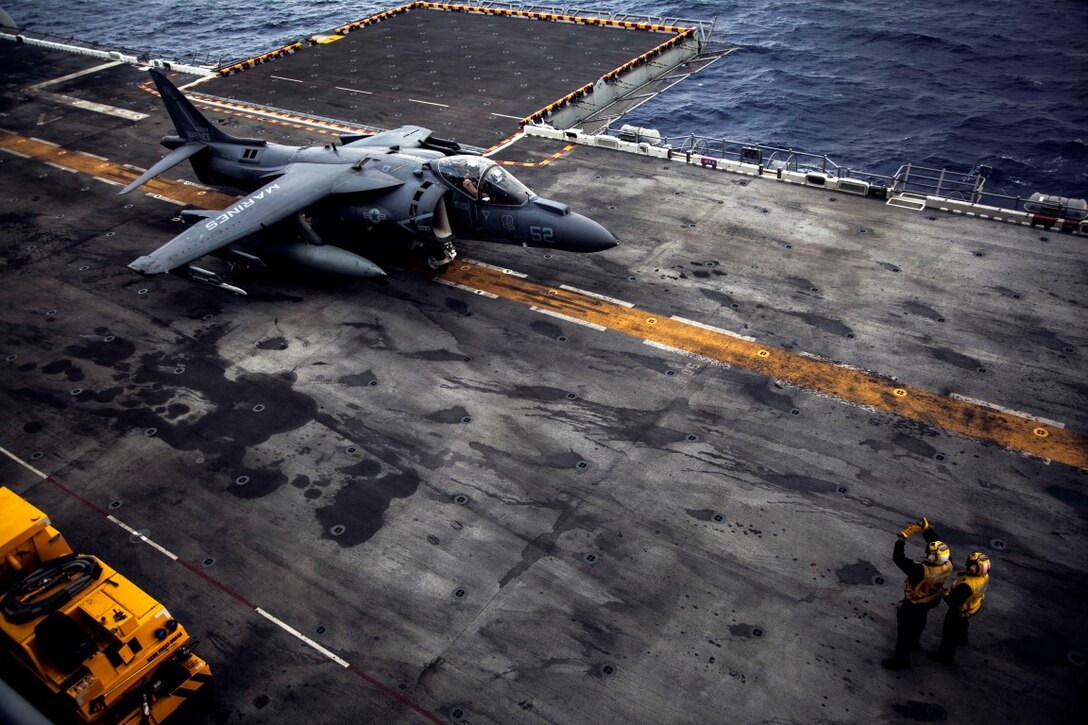 U.S. Sailors with the Essex Amphibious Ready Group signal to the pilot of an AV-8B Harrier with Marine Medium TIltrotor Squadron 161 (Reinforced), 15th Marine Expeditionary Unit, rolls into position on the flight deck of the USS Essex (LDH 2) at sea in the Pacific Ocean, May 13, 2015. 15th MEU’s air combat element is launched and recovered Harriers to maintain readiness and proficiency during their seven-month deployment. (U.S. Marine Corps photo by Cpl. Elize McKelvey/Released)