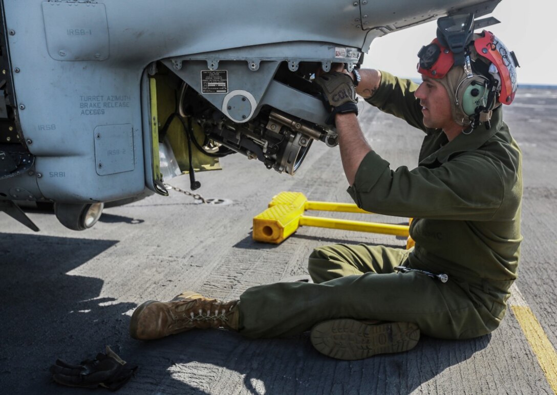 U.S. Marine Sgt. Ian T. Cole mounts an M197 20 mm automatic Gatling gun on an AH-1Z Viper aboard the USS Anchorage (LPD-23) at sea in the Pacific Ocean, May 14, 2015. Cole is an aviation ordnance technician with Marine Medium Tiltrotor Squadron 161 (Reinforced), 15th Marine Expeditionary Unit . The Marines and Sailors of the 15th MEU constantly perform maintenance on their equipment to maintain a constant state of combat readiness while deployed. (U.S. Marine Corps photo by Cpl. Steve H. Lopez/ Released)