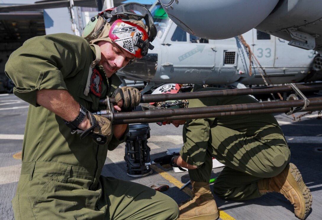 U.S. Marine Sgt. Ian T. Cole mounts a barrel of an M197 20 mm automatic Gatling gun on an AH-1Z Viper aboard the USS Anchorage (LPD-23) at sea in the Pacific Ocean, May 14, 2015. Cole is an aviation ordnance technician with Marine Medium Tiltrotor Squadron 161 (Reinforced), 15th Marine Expeditionary Unit. The Marines and Sailors of the 15th MEU constantly perform maintenance on their equipment to maintain a constant state of combat readiness while deployed. (U.S. Marine Corps photo by Cpl. Steve H. Lopez/Released)