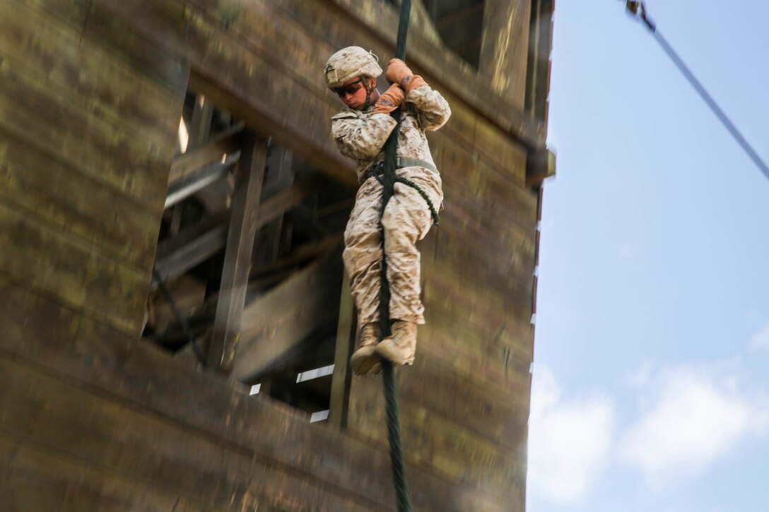 U.S. Marine Lance Cpl. Zane Harmon fast ropes from a tower aboard Marine Corps Base Hawaii, May 12, 2015. Harmon is part of the 15th Marine Expeditionary Unit’s Maritime Raid Force security element. These Marines practice fast roping to ensure they are prepared for any type of mission during deployment. (U.S. Marine Corps photo by Cpl. Anna Albrecht/Released)