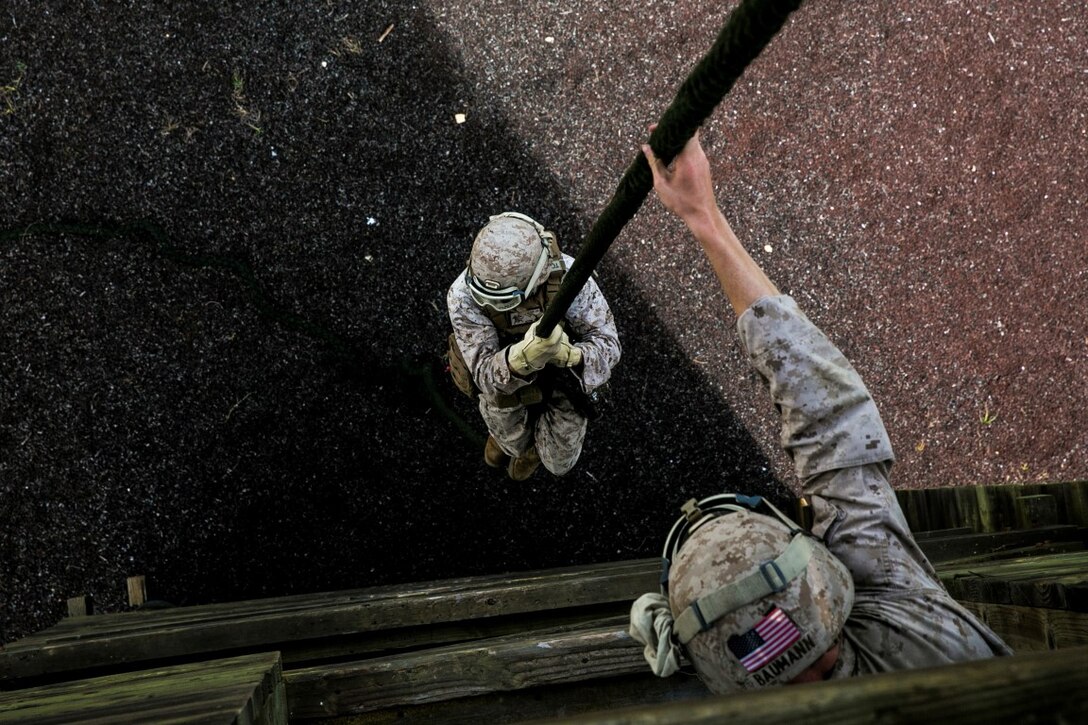U.S. Marines with the 15th Marine Expeditionary Unit’s Maritime Raid Force practice fast roping aboard Marine Corps Base Hawaii, May 12, 2015. These Marines are with Battalion Landing Team 3rd Battalion, 1st Marine Regiment and are assigned to the MRF’s security element. (U.S. Marine Corps photo by Cpl. Anna Albrecht/Released)