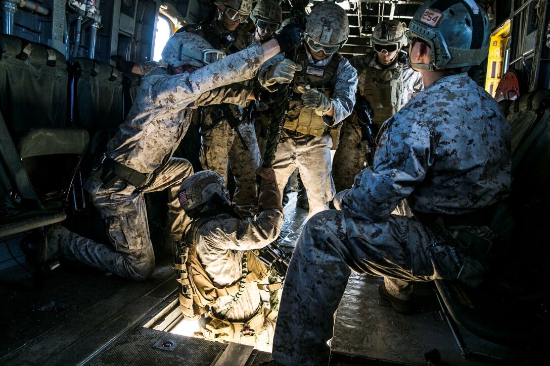 U.S. Marines with the 15th Marine Expeditionary Unit’s Maritime Raid Force security element fast rope out of a CH-53E Super Stallion aboard Marine Corps Base Hawaii, May 12, 2015. Fast roping is an essential skill for the security element because it allows them to rapidly insert into an objective while avoiding potential ground obstacles or enemy forces, or into zones where aircraft cannot land. (U.S. Marine Corps photo by Cpl. Anna Albrecht/ Released)