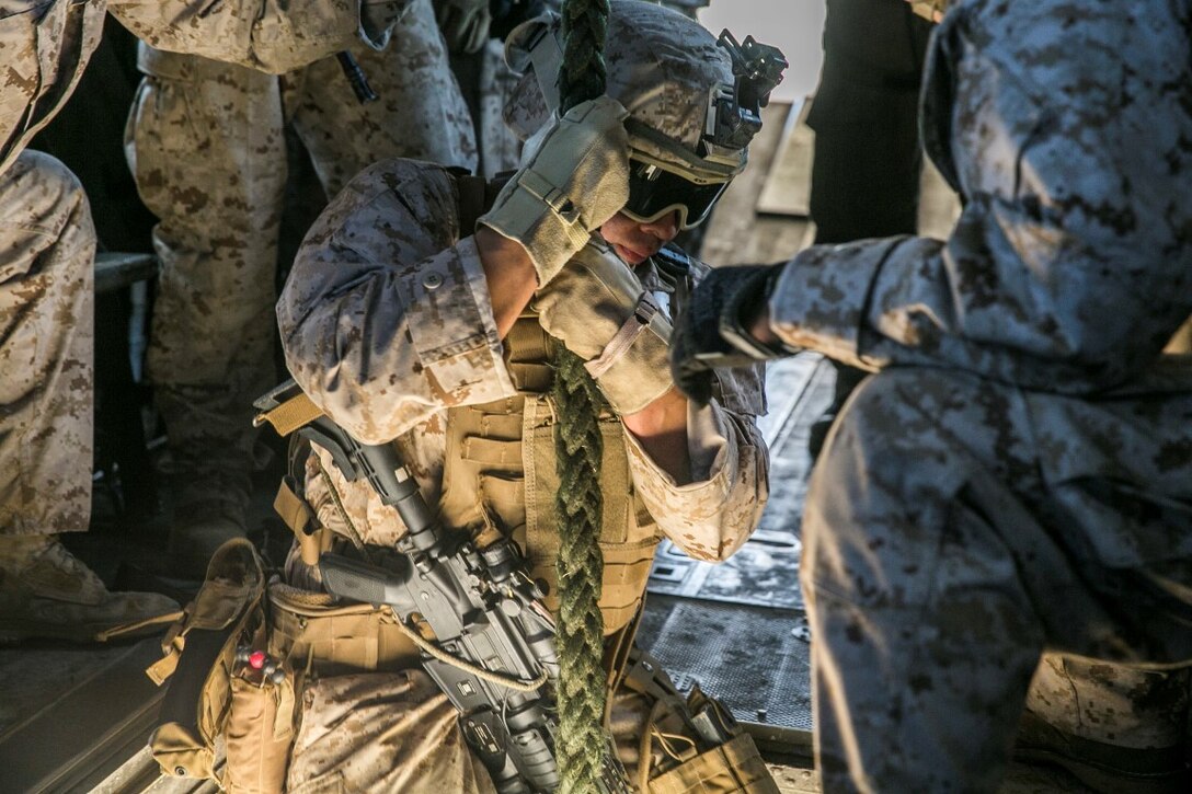 U.S. Marine Cpl. Chris Pecino fast ropes from a CH-53E Super Stallion aboard Marine Corps Base Hawaii, May 12, 2015. Pecino is with the 15th Marine Expeditionary Unit’s Maritime Raid Force security element. These Marines practice fast roping to ensure they are prepared for any type of insert during a mission. (U.S. Marine Corps photo by Cpl. Anna Albrecht/Released)