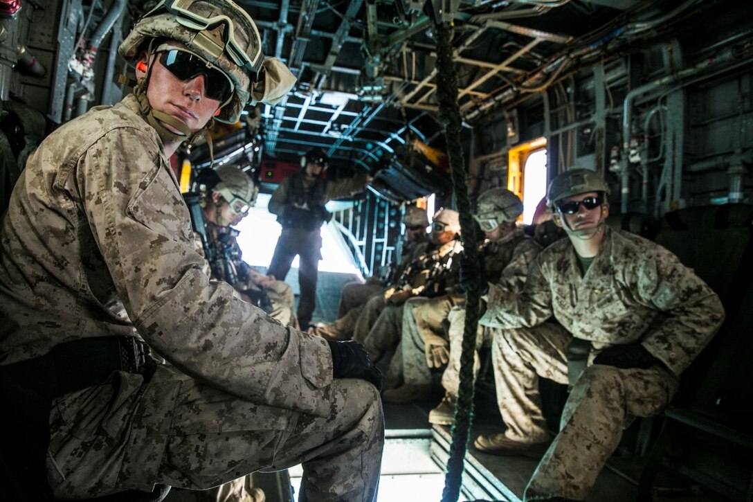 U.S. Marines with the 15th Marine Expeditionary Unit’s Maritime Raid Force security element prepare to fast rope from a CH-53E Super Stallion aboard Marine Corps Base Hawaii, May 12, 2015. These Marines practice fast roping to ensure they are prepared for any type of insert during a mission. (U.S. Marine Corps photo by Cpl. Anna Albrecht/Released)