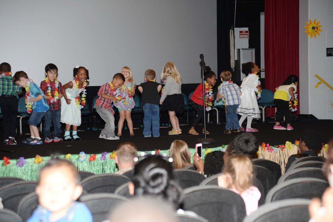 Graduating Pre-K students display a variety of animated gestures, facial expressions and dance moves, while singing and performing for the audience to the popular children’s group dance  and song, “Tooty Ta.” The ceremony was held at Marine Corps Logistics Base Albany’s Base Theater during the Child Development Center’s End of Year Program, here, May 19.