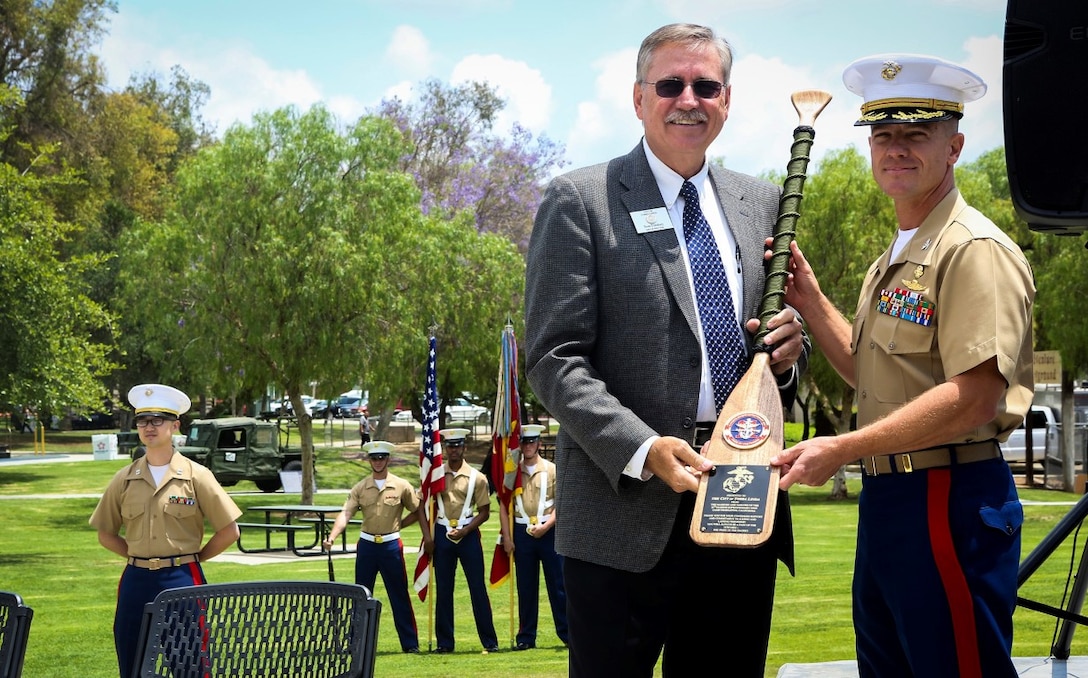 Tom Lindsey, left, City of Yorba Linda mayor pro tem, and Col. Matthew Trollinger, 11th Marine Expeditionary Unit commanding officer, exchange gifts during the 11th MEU adoption ceremony in the city of Yorba Linda, Calif. May, 16, 2015. The adoption represents a pledge to support service members and their families when the unit is deployed and at home, and maintains a constant link between Yorba Linda and the military community. The 11the MEU is a flexible, adaptable, and persistent force capable of rapidly responding to crises and contingencies. (U.S. Marine Corps photos by Cpl. Rick Hurtado/Released)