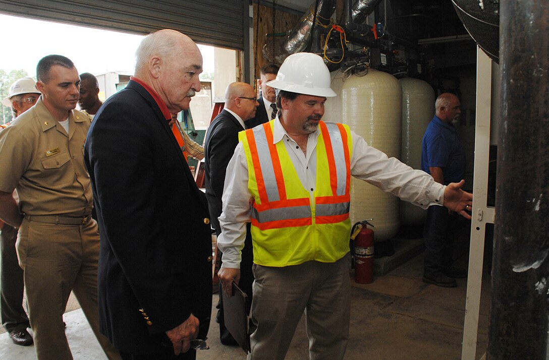 Assistant Secretary of the Navy, the Honorable Dennis V. McGinn (center), Energy, Installations and Environment, tours the ground source heat pump project area with Charles W. Hammock Jr., vice president, Andrews, Hammock and Powell, INC., during his visit to Marine Corps Logistics Base Albany, Georgia, May 19. The project is a borehole thermal energy storage system which is a state-of-the-art ground source heat pump system for heating and cooling Building 3700, the Marine Corps Logistics Command headquarters building.  