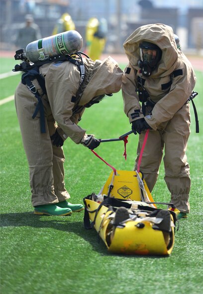 Exhaustion takes its toll as competitors in the second Annual Marine Responders Fitness Test perform the body drag event around the Mustang track of Osan Air Base, Republic of Korea, March 20, 2015. The four participating teams suited up in two types of full class B CBRNE protection suits to perform a series of tasks, gaining points for speed and oxygen conservation.
(USAF photo by Staff Sgt. Amber Grimm)