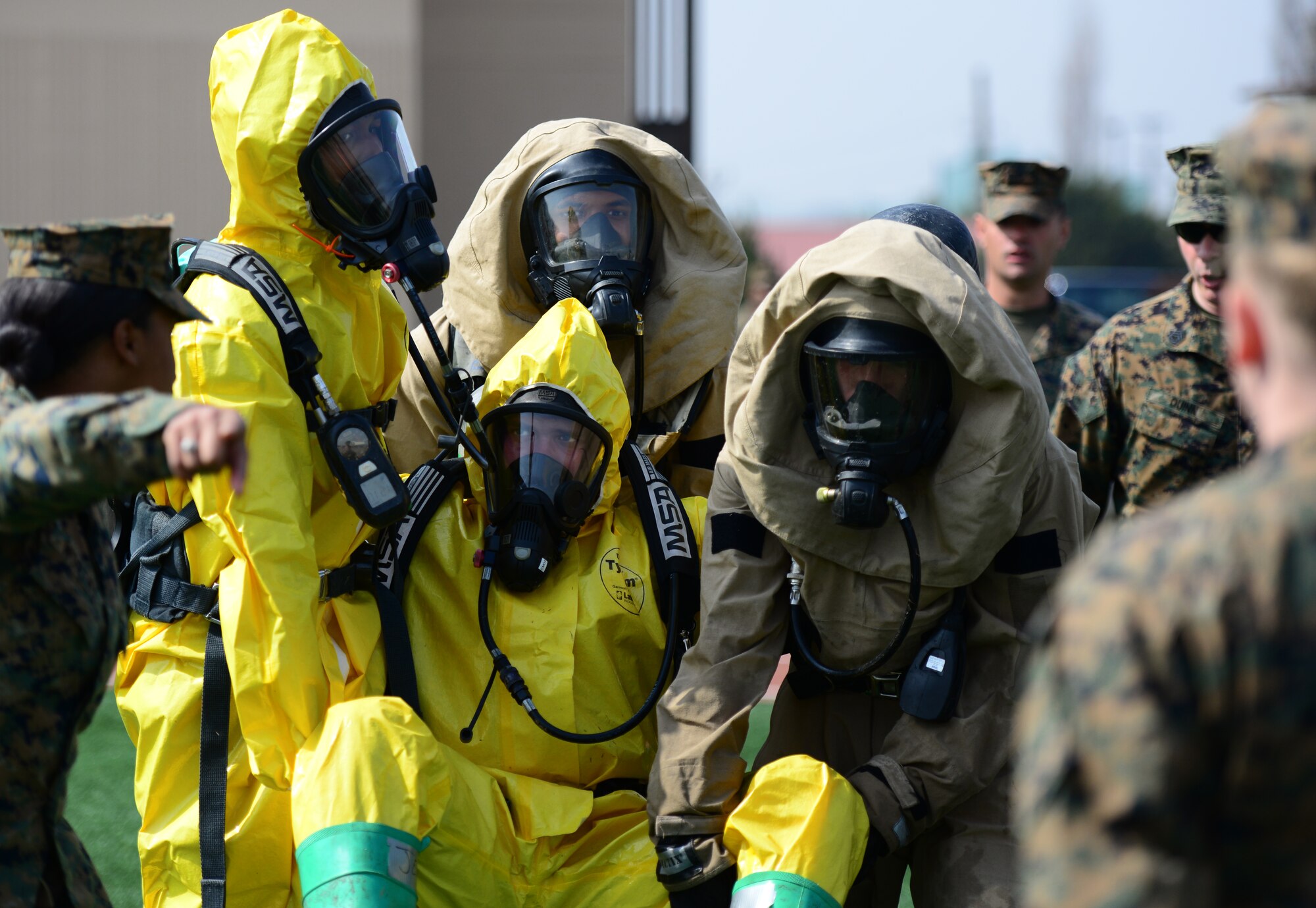 Cheered on by fellow members of the Corps, the four man team of Emergency Managers from the 1st Marine Aircraft Wing out of Camp Foster, Japan muscle through the last task in the second Annual Marine Responders Fitness Test, March 20, 2015 at Osan Air Base, Republic of Korea.  The four participating teams suited up in two types of full class B CBRNE protection suits to perform a series of tasks, gaining points for speed and oxygen conservation.
(USAF photo by Staff Sgt. Amber Grimm)