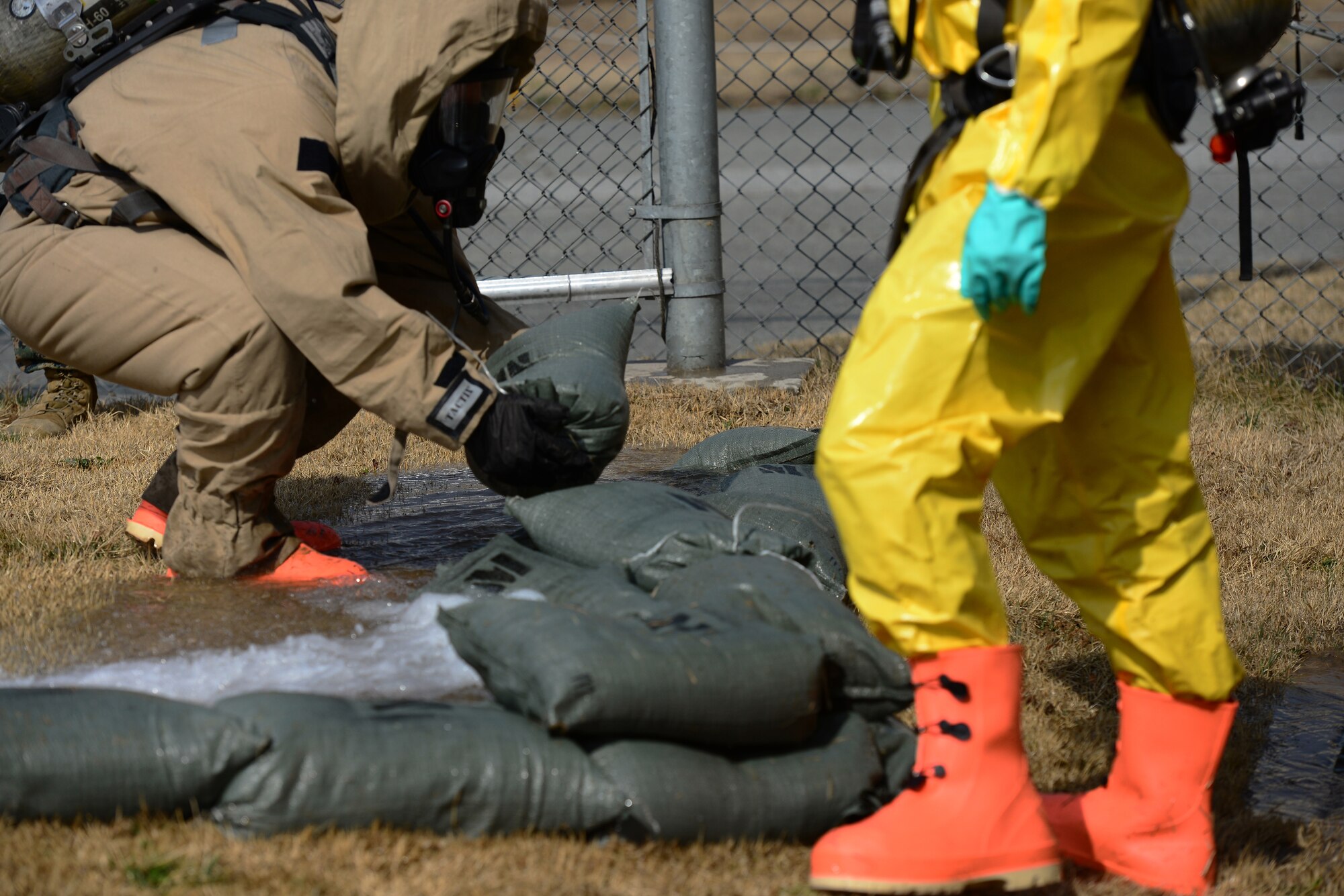 A team of competitors in the second Annual Marine Responders Fitness Test place sandbags to channel water flow away from a drain during the Dam, Dyke and Diverting portion of the event on March 20, 2015 at Osan Air Base, Republic of Korea. The four participating teams suited up in two types of full class B CBRNE protection suits to perform a series of tasks, gaining points for speed and oxygen conservation.
(USAF photo by Staff Sgt. Amber Grimm)
