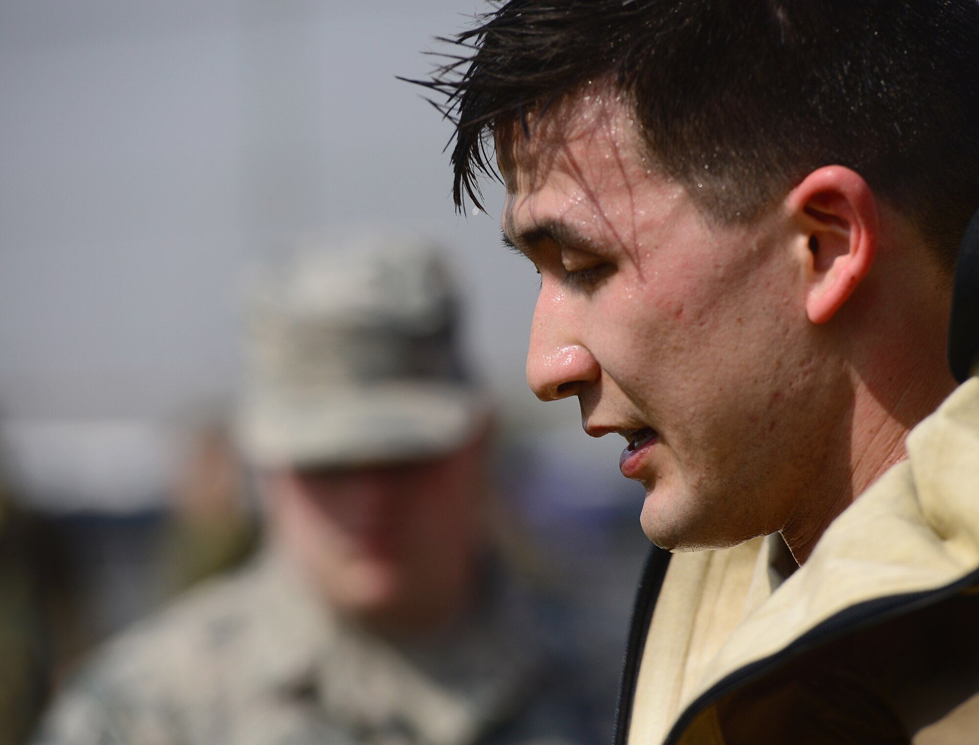 Sweat drips off Senior Airman Robert Gauthier as he recovers after completing all tasks of the competition held March 20, 2015 at Osan Air Base, Republic of Korea. Senior Airman Gauthier was a part of the four man team of Firefighters from the 51st Civil Engineer Squadron that won the second Annual Marine Responders Fitness Test. 
(USAF photo by Staff Sgt. Amber Grimm)