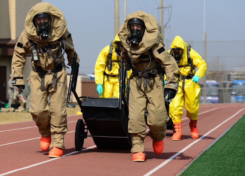The 51st Civil Engineer Firefighter team pull handcarts loaded with 200 pounds worth of sandbags around the base outdoor track during the second Annual Marine Responders Fitness Test, March 20, 2015 at Osan Air Base, Republic of Korea. The four participating teams suited up in two types of full class B CBRNE protection suits to perform a series of tasks, gaining points for speed and oxygen conservation.
(USAF photo by Staff Sgt. Amber Grimm)