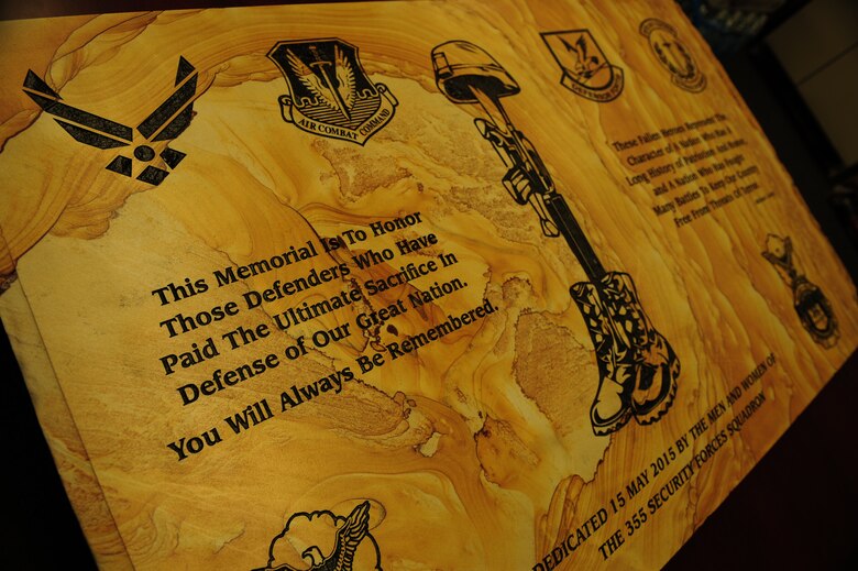 A memorial displayed in the 355th Security Forces Squadron honors fallen security forces personnel at Davis-Monthan Air Force Base Ariz., May 18, 2015. The memorial was presented during a retreat ceremony at Heritage Park May 14. A 3-volley salute was conducted to honor security forces Airmen that paid the ultimate sacrifice. (U.S. Air Force photo by Airman 1st Class Chris Drzazgowski/Released)  