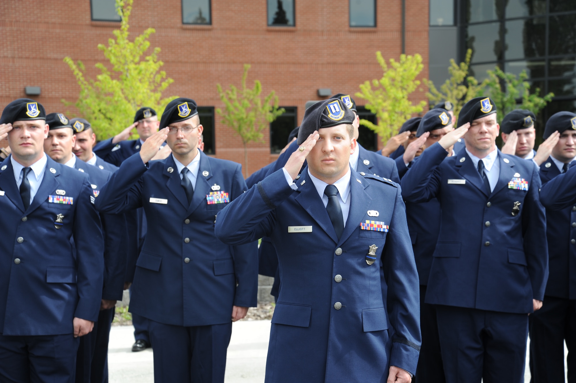 Members from the 92nd Security Forces Squadron salute during the retreat ceremony May 15, 2015, at Fairchild Air Force Base, Wash. Airmen from around Fairchild attended the retreat ceremony that paid special recognition to those law enforcement officers who have lost their lives in the line of duty for the safety and protection of others. (U.S. Air Force photo/Airman 1st Class Nicolo J. Daniello)