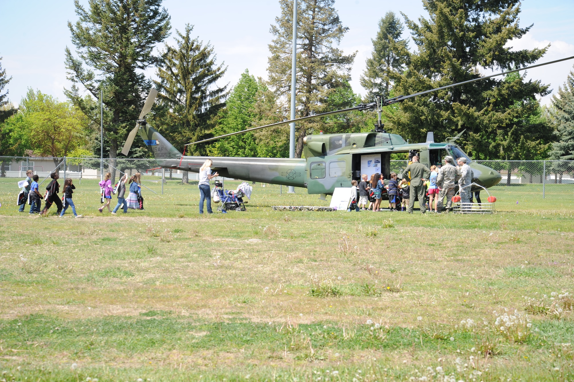 Children from Michael Anderson Elementary School inspect a UH-1N Iroquois “Huey” helicopter May 11, 2015, at Fairchild Air Force Base, Wash. Children had the opportunity to go inside the helicopter and sit in the pilot seat behind the controls. National Police Week is a collaborative effort of many organizations dedicated to honoring America's law enforcement community. (U.S. Air Force photo/Airman 1st Class Nicolo J. Daniello)