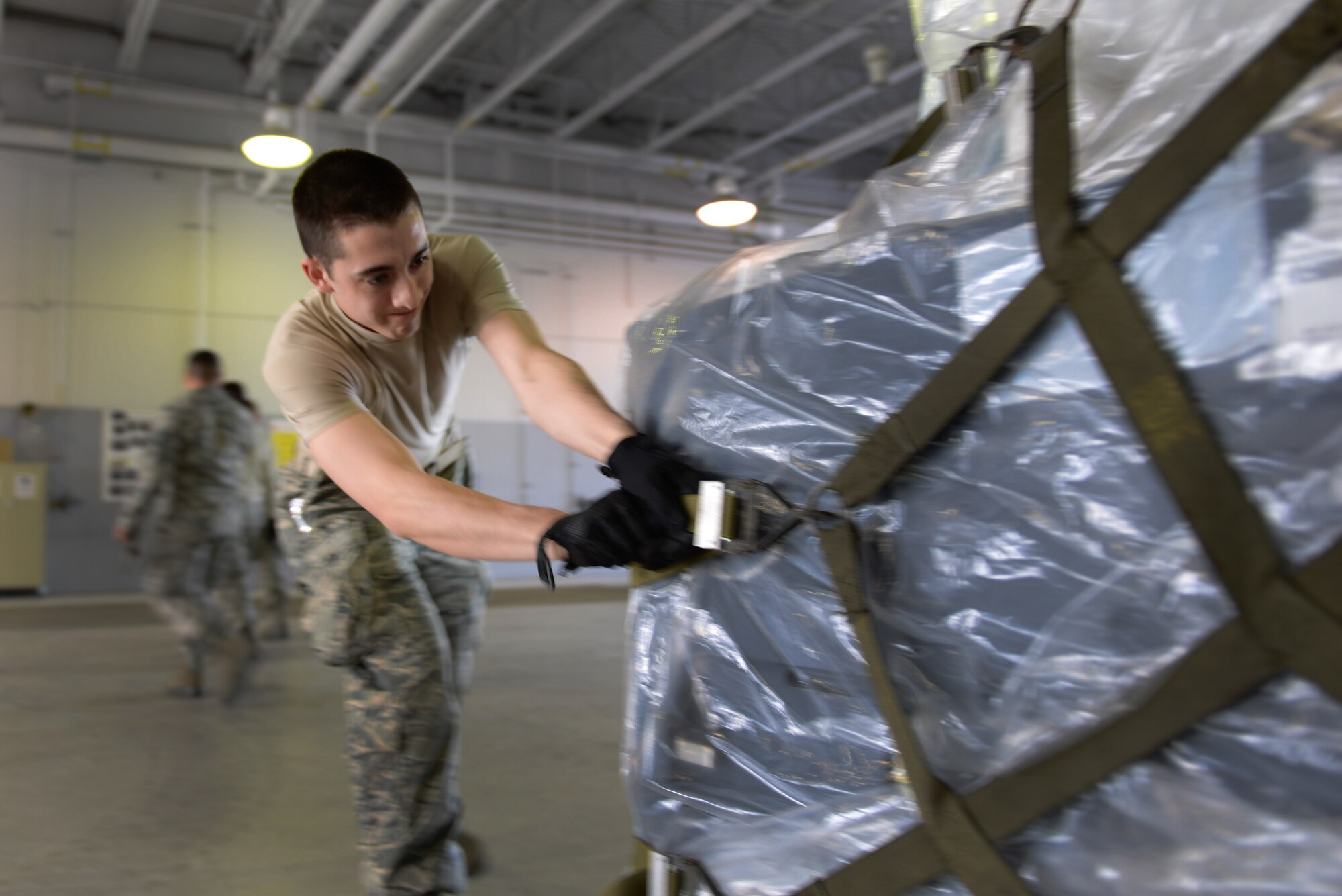 U.S. Air Force Senior Airman Daniel Ojeda, a 354th Logistics Readiness Squadron traffic management journeyman, secures a cargo net May 14, 2015, during RED FLAG-Alaska (RF-A) 15-2 at Eielson Air Force Base, Alaska. The 354th LRS serves as a liaison between RF-A participants and the Air Mobility Command function. (U.S. Air Force photo by Senior Airman Ashley Nicole Taylor/Released)