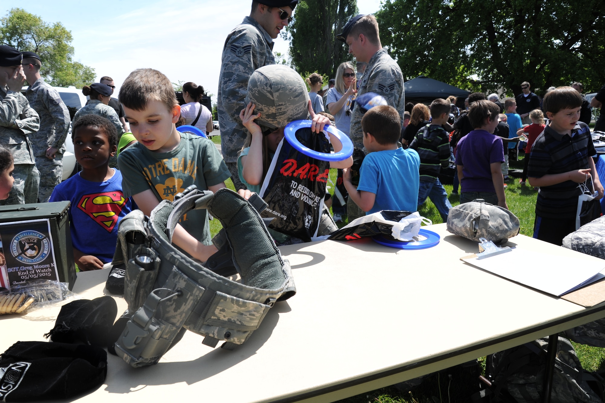 Children from Michael Anderson Elementary School try on security forces helmets and equipment belts May 11, 2015, at Fairchild Air Force Base, Wash. The children had the opportunity to speak with different law enforcement agencies such as 92nd Security Forces Squadron personnel, local police department officials, representatives from D.A.R.E., Alcohol Tobacco and Firearms members, and SWAT personnel. (U.S. Air Force photo/Airman 1st Class Nicolo J. Daniello)