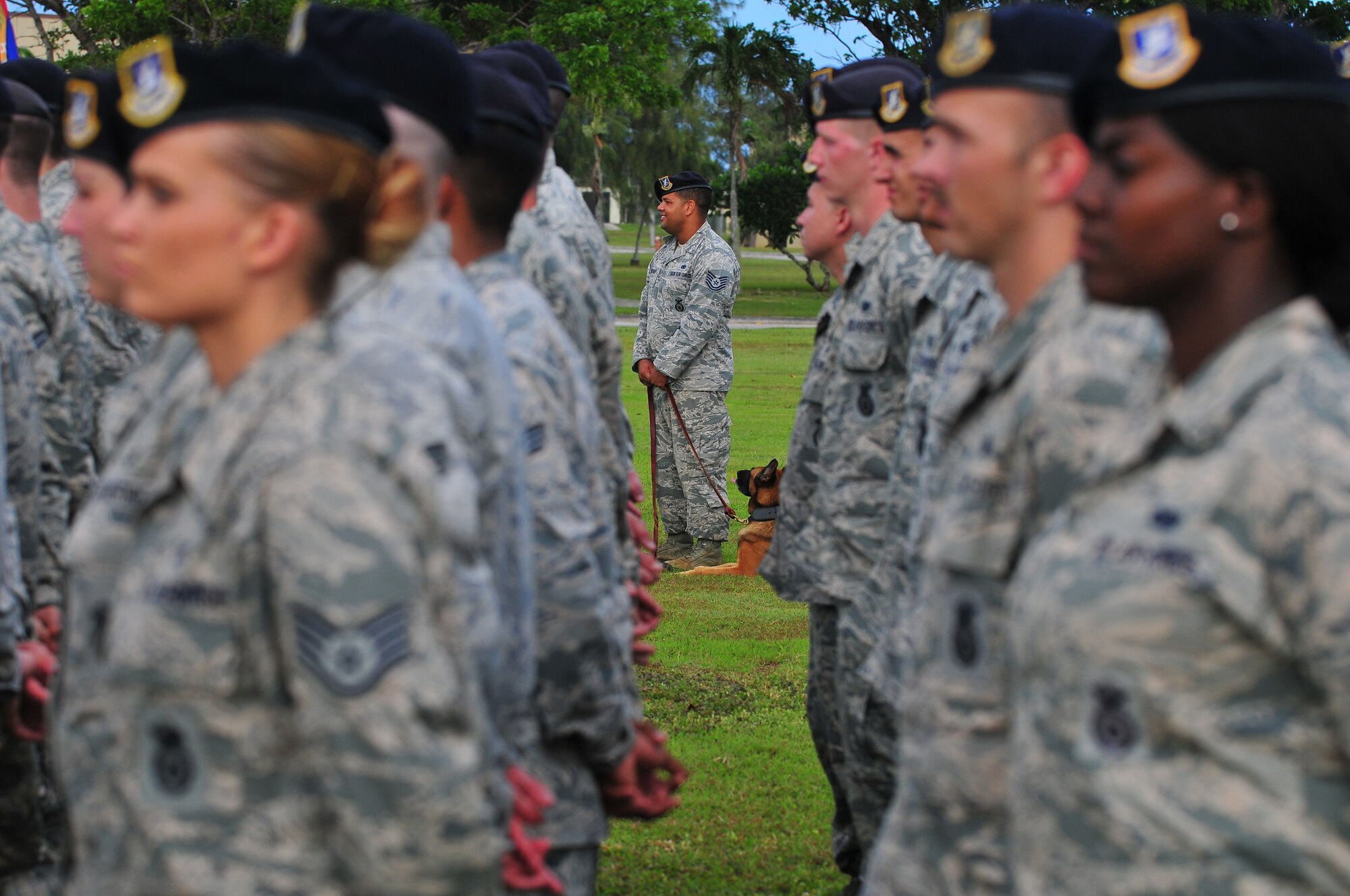 Tech. Sgt. Jeremy Toliver, a 36th Security Forces Squadron MWD handler, and his military working dog stand in formation during a retreat ceremony in honor of National Police Week, May 13, 2015, at Andersen Air Force Base, Guam. The ceremony recognized law enforcement professionals in honor of National Police Week. (U.S. Air Force photo by Senior Airman Alexander W. Riedel/Released) 