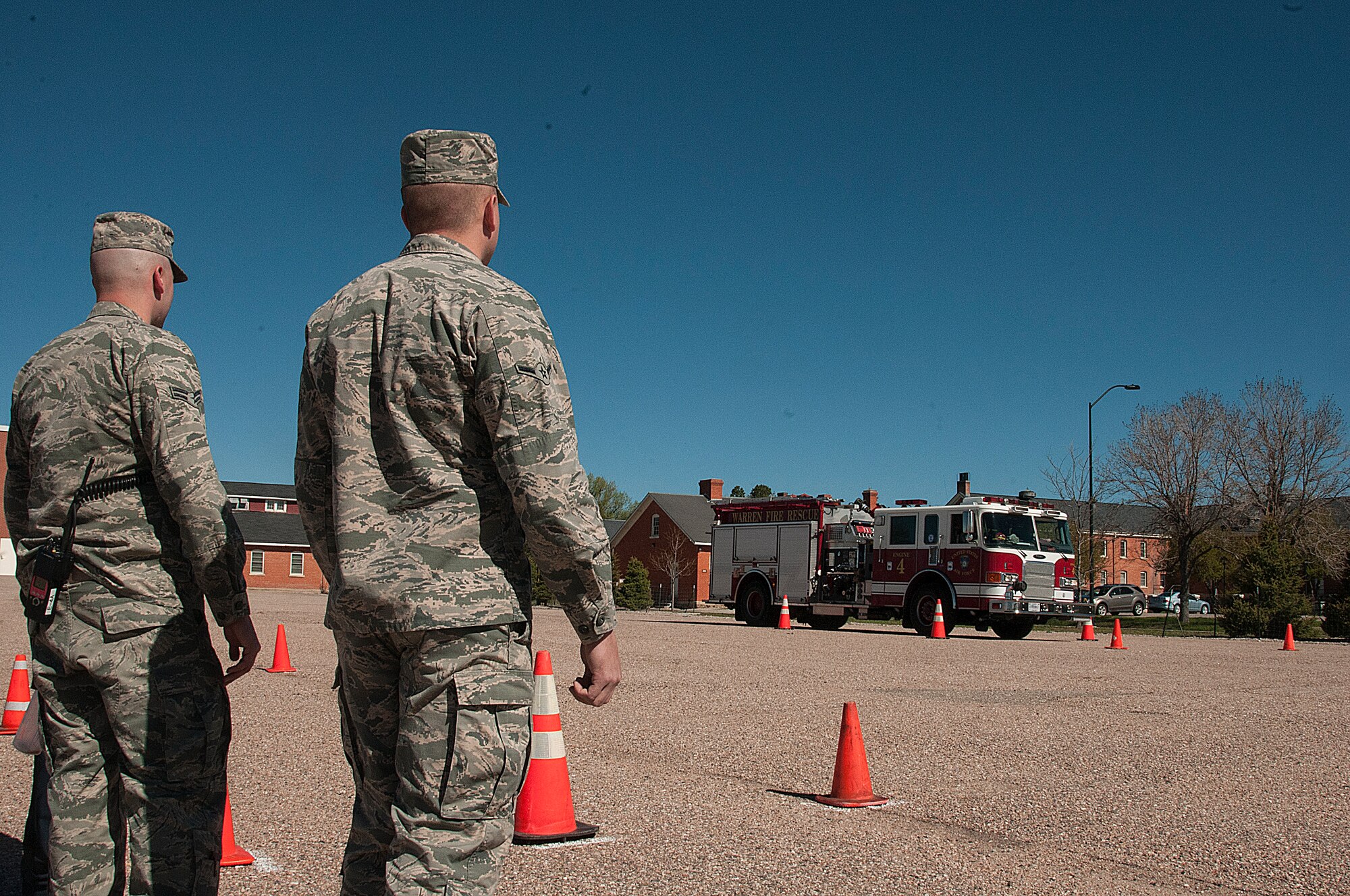 Airman 1st Class Donald Emerson and Airman Tom Werre, 90th Civil Engineer Squadron firefighters, observe as Airman 1st Class Augustus Whitt, 90th CES firefighter, navigates cones during P22 fire truck training May 16, 2015, on F.E. Warren Air Force Base, Wyo. To pass the course, drivers must complete the course within 30 minutes without knocking too many cones. (U.S. Air Force photo by Senior Airman Jason Wiese)