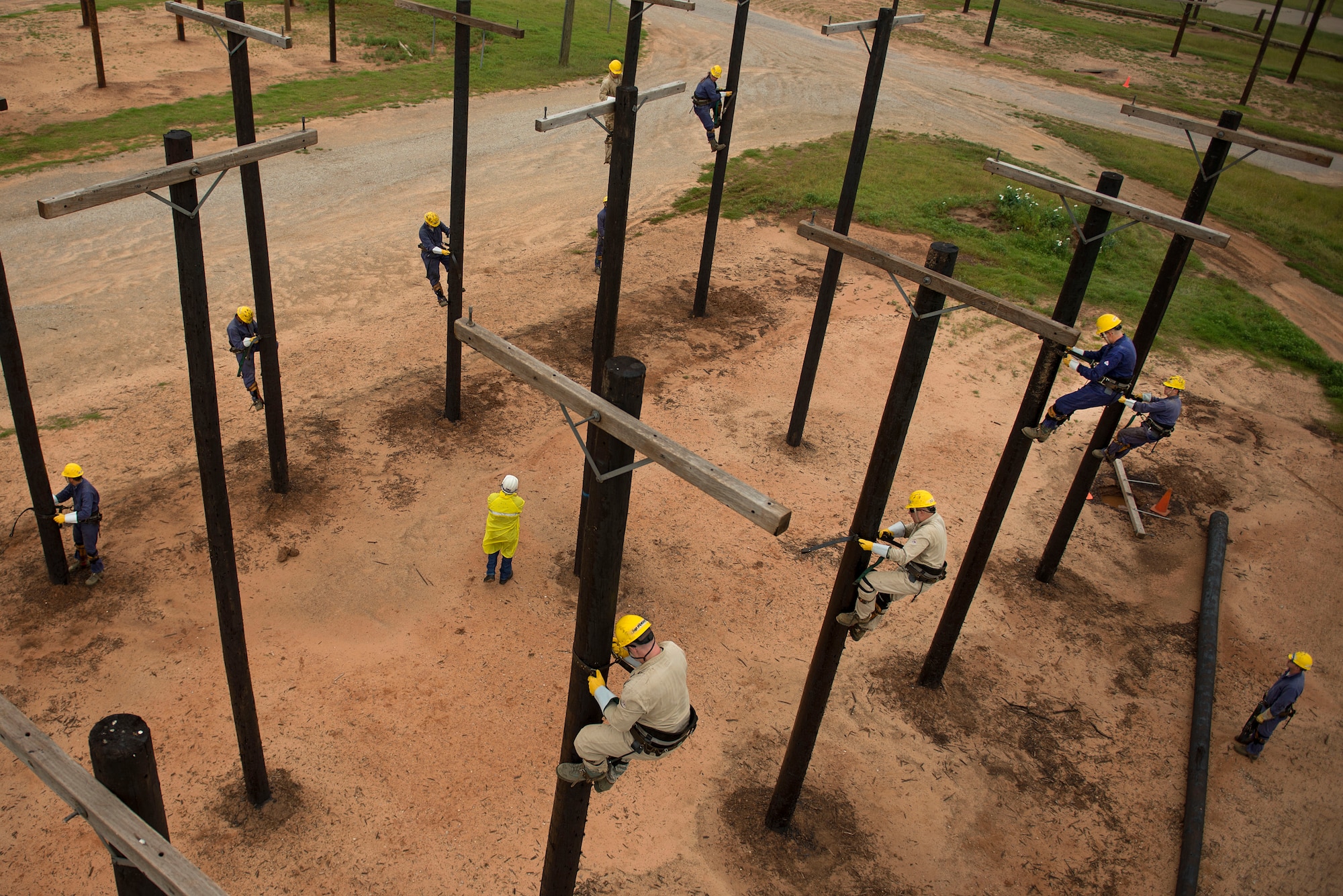 U.S. Air Force Airmen climb utility poles during their training at Sheppard Air Force Base, Texas, May 19, 2015. The electronic systems apprentice or power-line distribution course, teaches students how to use, install and maintain electrical equipment necessary for mission success. (U.S. Air Force photo by Senior Airman Kyle Gese/Released)
