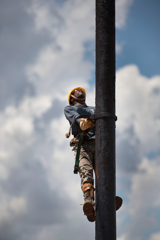 U.S. Air Force Airman 1st Class Maurice Price, 366th Training Squadron student, climbs a utility pole as part of his training at Sheppard Air Force Base, Texas, May 18, 2015. The mission of the 82nd Training Wing is to train and inspire warriors. Price is a native of Dover, Del., attending a six-month training course at Sheppard for electronic systems. (U.S. Air Force photo by Senior Airman Kyle Gese/Released)
