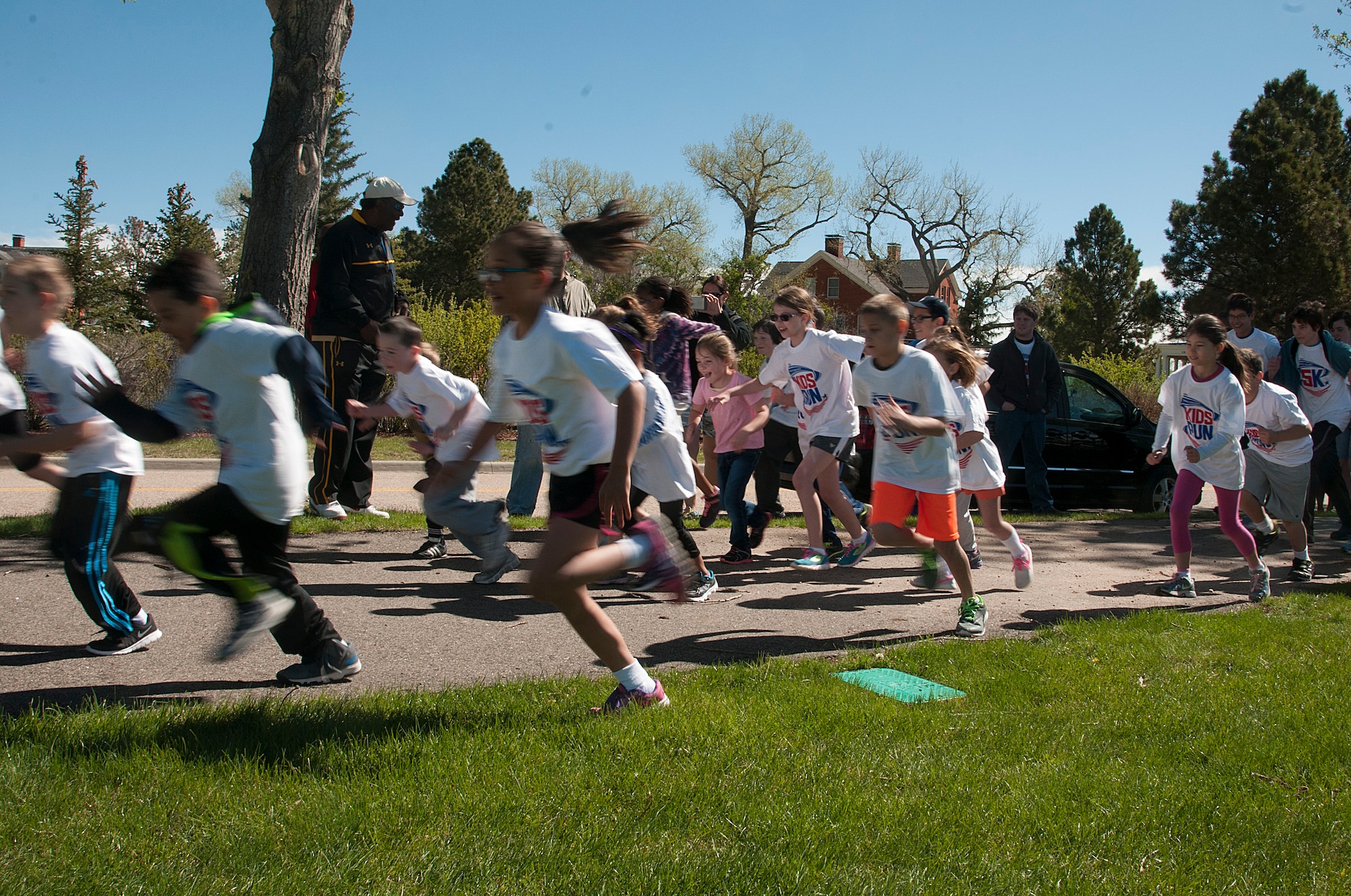 Children take off at the start of the America’s Kids Run race May 16, 2015, on the track around the Argonne Parade Field on F.E. Warren Air Force Base, Wyo. America’s Kids Run is an armed forces-wide race for dependent children held in May each year. (U.S. Air Force photo by Senior Airman Jason Wiese)