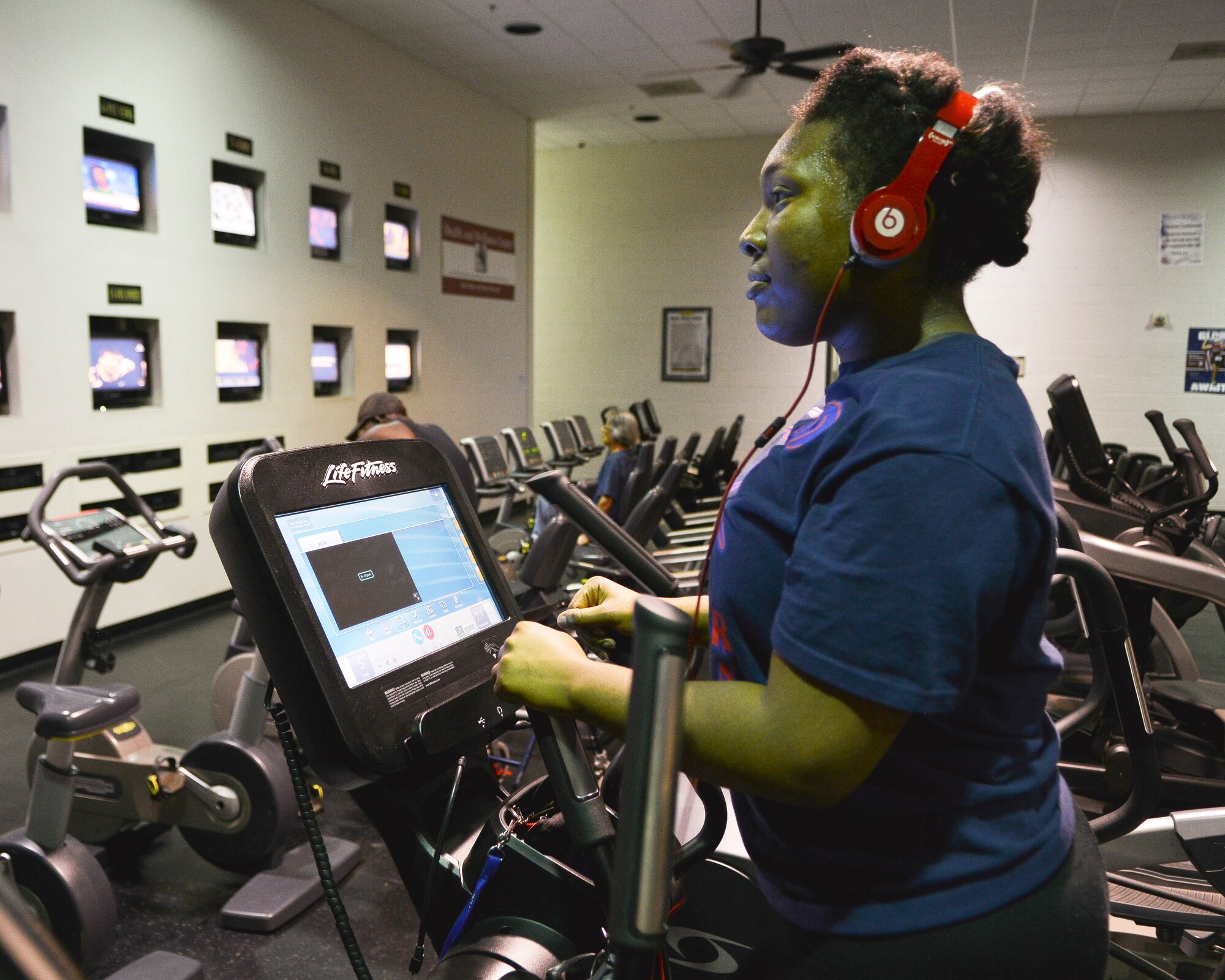 Mikalia Bradberry exercises on an elliptical machine May 18, 2015, at Dyess Air Force Base, Texas. The Dyess Fitness Center began a 24-hour fitness program, which allows military members, dependents and retirees to utilize the fitness center at any time. (U.S. Air Force photo by Airman 1st Class Kedesha Pennant/Released)