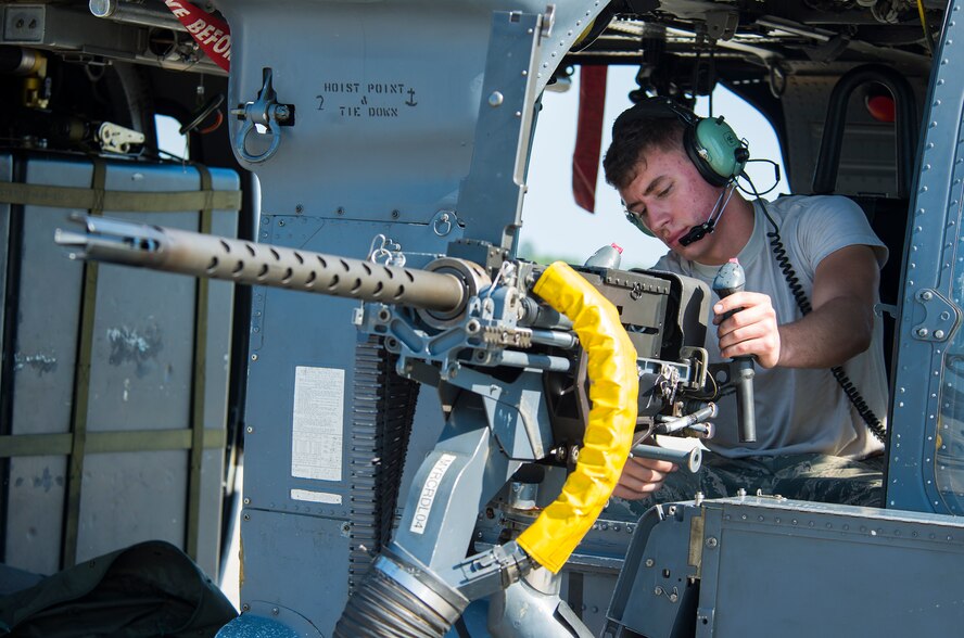 U.S. Air Force Senior Airman Cleveland Green, 41st Helicopter Maintenance Unit weapons load team member, performs a functional check during the 23d Wing weapons load competition May 18, 2015, at Moody Air Force Base, Ga. The 41st HMU leadership selected two members from the unit to compete based on their performance and abilities. (U.S. Air Force photo by Airman 1st Class Ceaira Tinsley/Released)