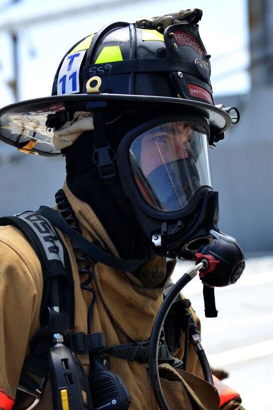 Jesse Baker, Naval Station Norfolk firefighter, participates in the 24th Annual Hampton Roads Marine Firefighting School maritime incident response exercise at Fort Eustis, Va., May 15, 2015. During the five-day school, civilian, military and international firefighters, learned of new maritime firefighting methods and exchanged techniques with one another. (U.S. Air Force photo by Staff Sgt. Natasha Stannard/Released)