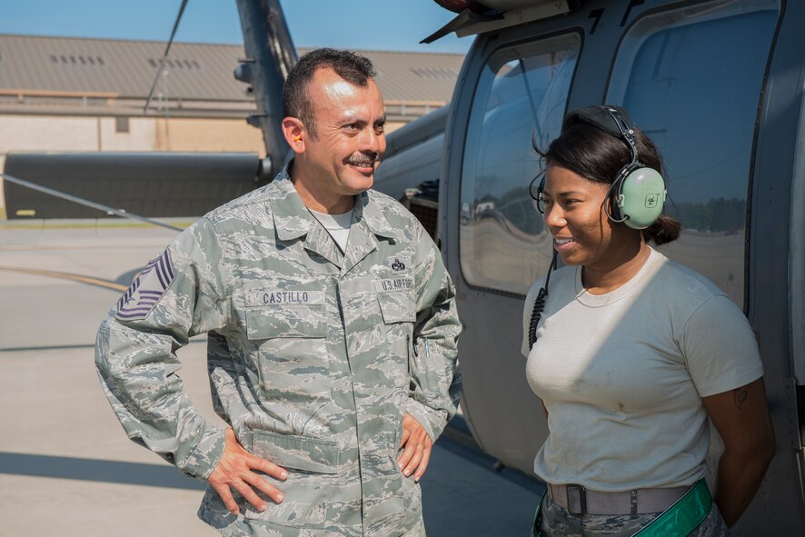 U.S. Air Force Chief Master Sgt. Guillermo Castillo Jr., 23d Maintenance Group weapons manager, left, and Staff Sgt. Tameka Lindsay, 41st Helicopter Maintenance Unit load crew chief, talk after the 23d Wing weapons load competition May 18, 2015, at Moody Air Force Base, Ga. The 23d WG is slated to announce the winning squadron later this week. (U.S. Air Force photo by Airman 1st Class Ceaira Tinsley/Released)