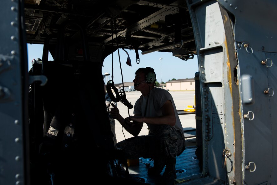 U.S. Air Force Senior Airman Cleveland Green, 41st Helicopter Maintenance Unit weapons load team member, performs a functional check during the 23d Wing weapons load competition May 18, 2015, at Moody Air Force Base, Ga. The 41st HMU leadership selected two members from the unit to compete based on their performance and abilities. (U.S. Air Force photo by Airman 1st Class Ceaira Tinsley/Released)