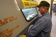 Bob Hassell, 341st Missile Maintenance Squadron corrosion shop mechanic, blasts a door handle to take off old paint and rust using a sand blaster May 14, 2015, at Malmstrom Air Force Base, Mont. Corrosion control focuses on preventative maintenance by sanding down and repainting launch and missile alert facility equipment. (U.S. Air Force photo/Chris Willis)