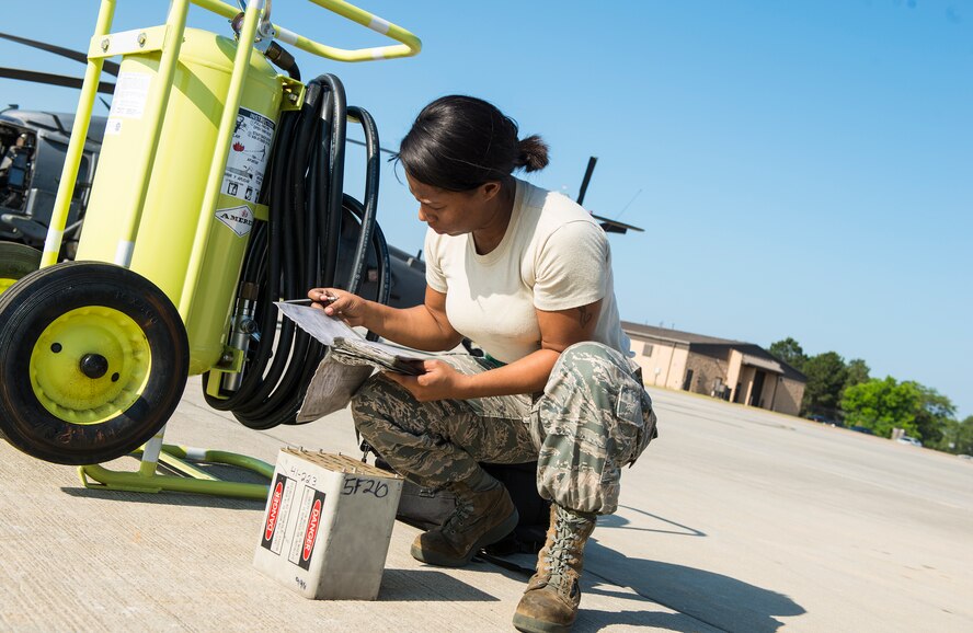 U.S. Air Force Staff Sgt. Tameka Lindsay, 41st Helicopter Maintenance Unit load crew chief, reviews a loading checklist May 18, 2015, at Moody Air Force Base, Ga. Lindsay checked the serviceability of a simulated flare before installing the flare magazine on the aircraft. (U.S. Air Force photo by Airman 1st Class Ceaira Tinsley/Released)