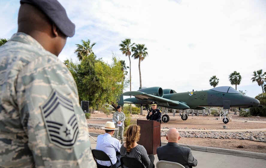 Service members and civilians listen as Tucson Police Capt. Michael Gillooly speaks about challenges and sacrifices law enforcement officials encounter, during a retreat ceremony for National Police Week at Davis-Monthan Air Force Base, Ariz., May 14, 2015. The ceremony honored security forces and other law enforcement members who have died in the line of duty. (U.S. Air Force photo by Staff Sgt. Angela Ruiz/released)