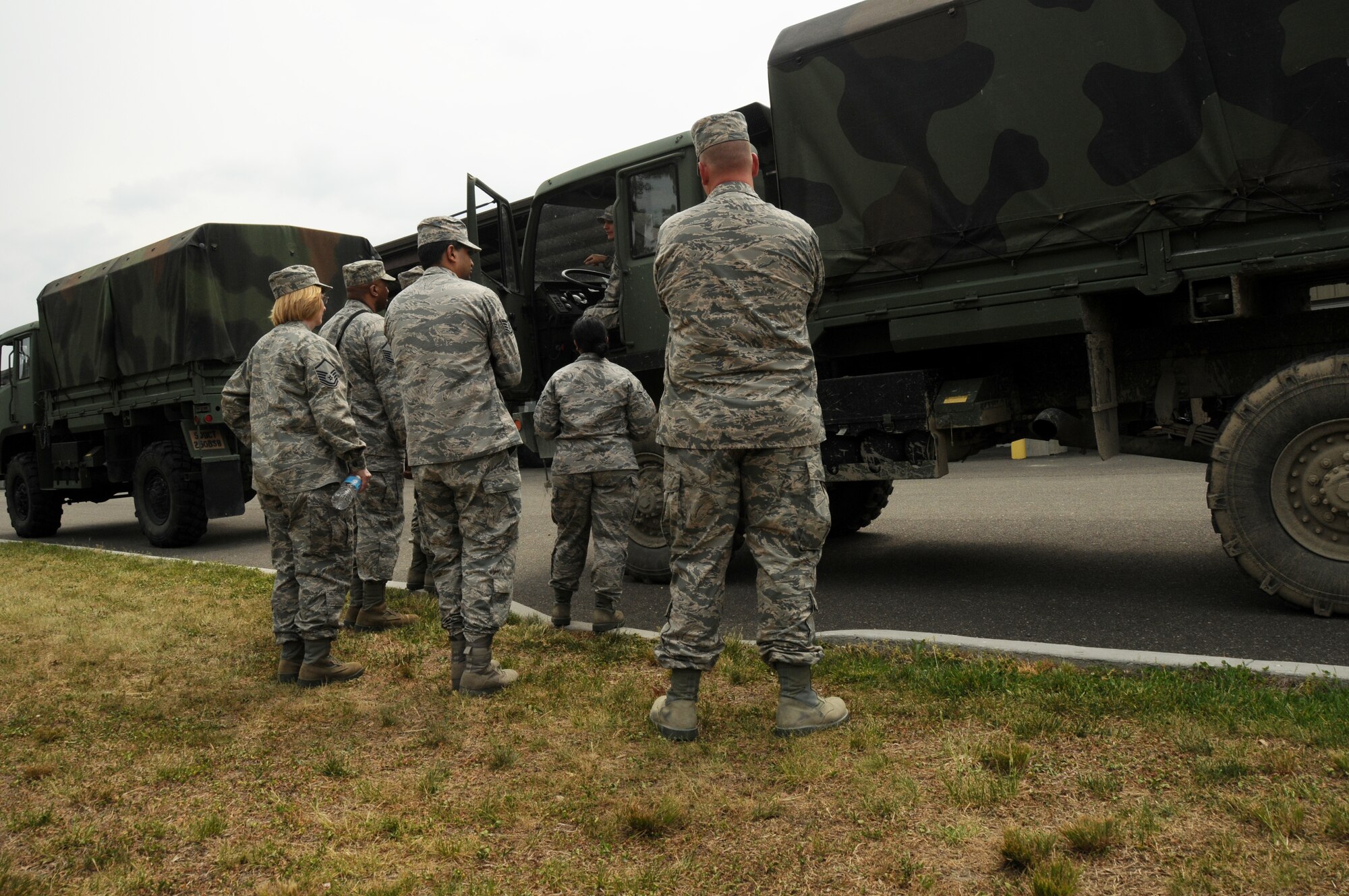 A picture of members of the 177th Fighter Wing Quick Reaction Force in front of a Light Medium Tactical Vehicle.