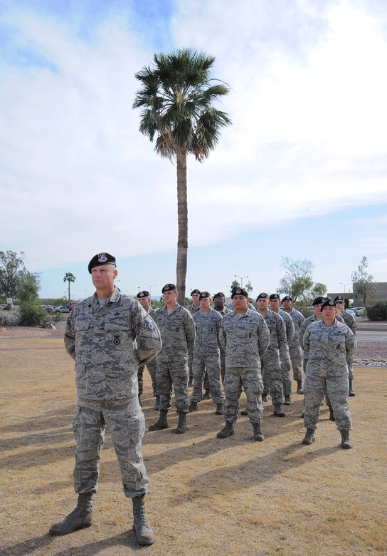 U.S. Air Force Master Sgt. Kyle Capehart, 355th Security Forces Squadron operations NCO-in-charge, commands a formation during a retreat ceremony for National Police Week at Davis-Monthan Air Force Base, Ariz., May 14, 2015. The formation initiated a roll call for fallen security forces Airmen and saluted the American flag during retreat. (U.S. Air Force photo by Staff Sgt. Angela Ruiz/released)