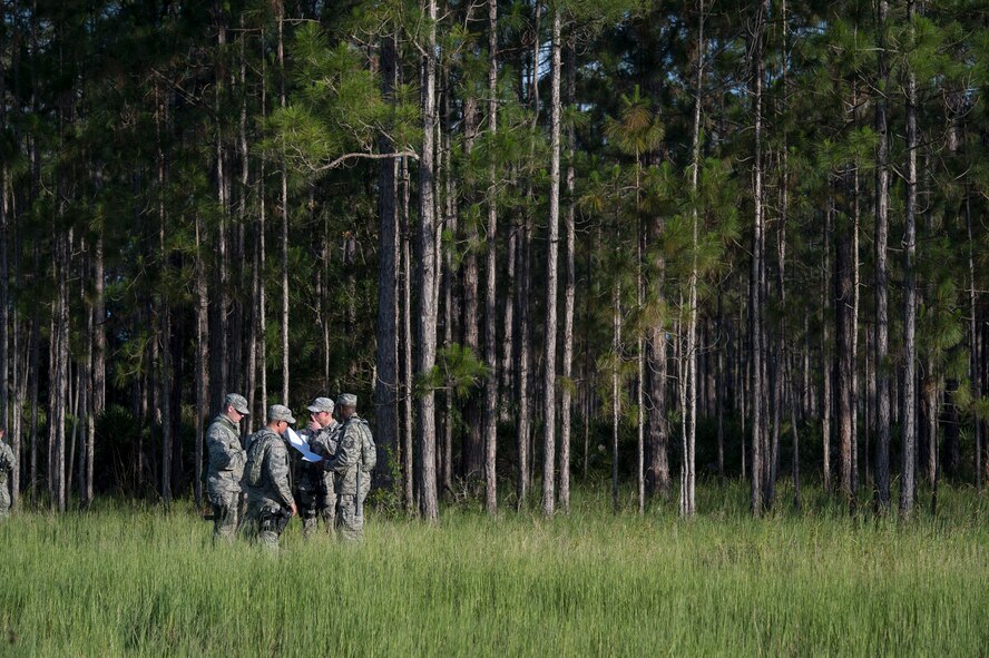 A fireteam from the 93d Air Ground Operations Wing checks a map prior to entering the woods in the midst of the land navigation event during Spartan Warrior May 12, 2015, at Avon Park Air Force Range, Fla. Twenty seven fireteams competed to find the most points within a 100 square mile area. (U.S. Air Force photo by Senior Airman Ryan Callaghan/Released)	

