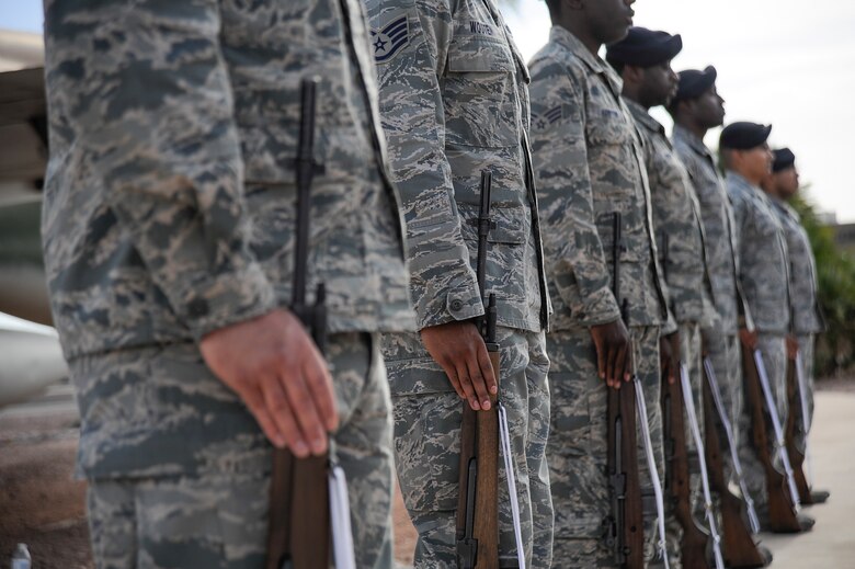 Airmen from the 355th Security Forces Squadron stand with their rifles during a retreat ceremony for National Police Week at Davis-Monthan Air Force Base, Ariz., May 14, 2015. The seven Airmen performed a 3-volley rifle salute for fallen security forces Airmen and fallen law enforcement. (U.S. Air Force photo by Staff Sgt. Angela Ruiz/released) 
