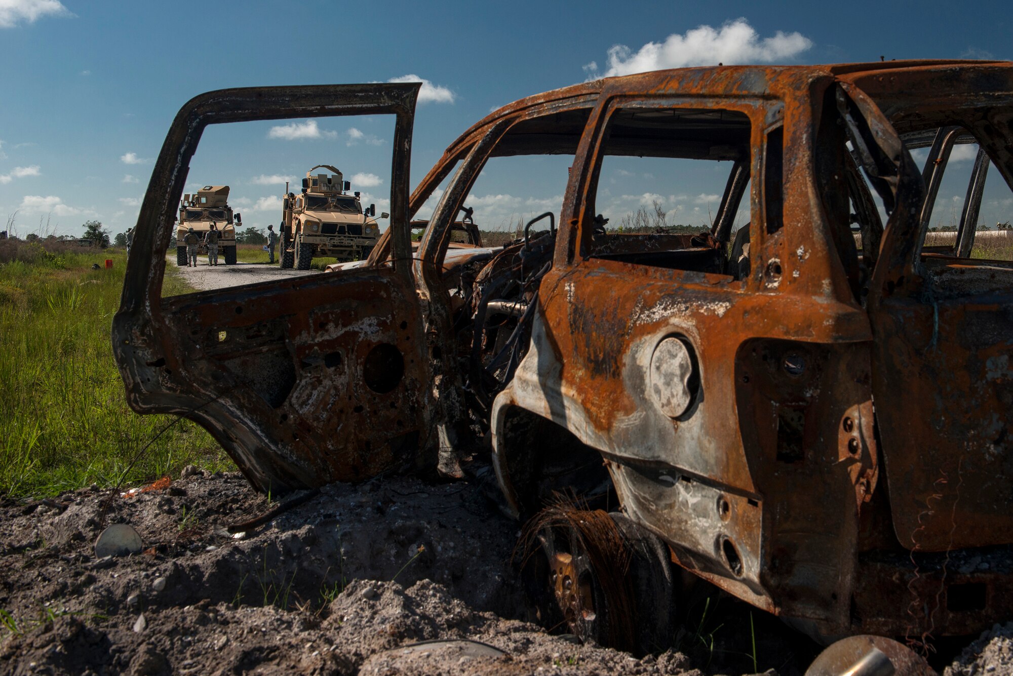 Airmen from the 820th Base Defense Group stand outside two mine resistant, ambush-protected vehicles during Spartan Warrior May 13, 2015, at Avon Park Air Force Range, Fla. During their functional area exercise, Airmen from the 820th BDG had to recover sensitive items from a simulated-disabled convoy vehicle. (U.S. Air Force photo by Senior Airman Ryan Callaghan/Released)


