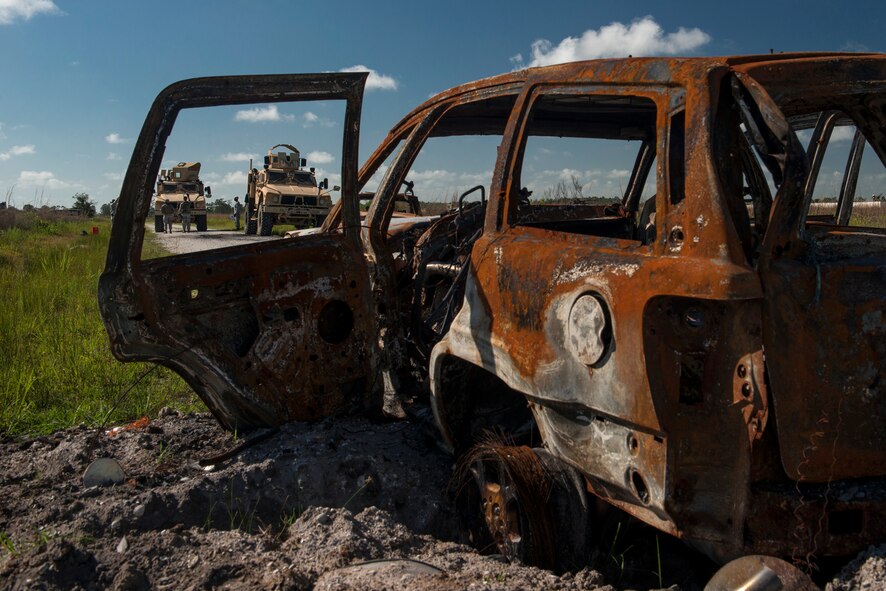 Airmen from the 820th Base Defense Group stand outside two mine resistant, ambush-protected vehicles during Spartan Warrior May 13, 2015, at Avon Park Air Force Range, Fla. During their functional area exercise, Airmen from the 820th BDG had to recover sensitive items from a simulated-disabled convoy vehicle. (U.S. Air Force photo by Senior Airman Ryan Callaghan/Released)

