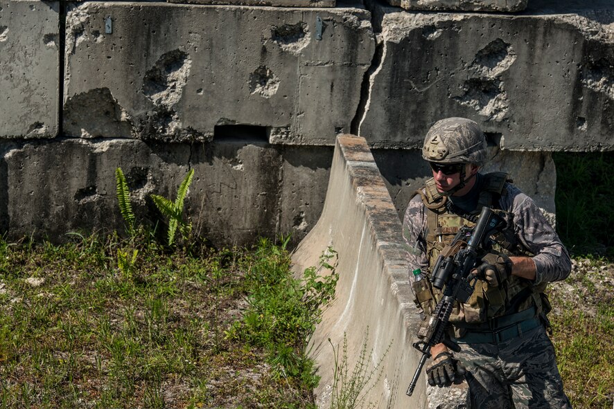 U.S. Air Force Senior Airman Andrew Galvin, 822nd Base Defense Squadron fireteam member, scans for signs of a hidden improved explosive device during Spartan Warrior May 13, 2015, at Avon Park Air Force Range, Fla. Airmen from the 820th BDG were tested on convoy operations, IED detection, building clearing and large weapons disassembly and reassembly. (U.S. Air Force photo by Senior Airman Ryan Callaghan/Released)


