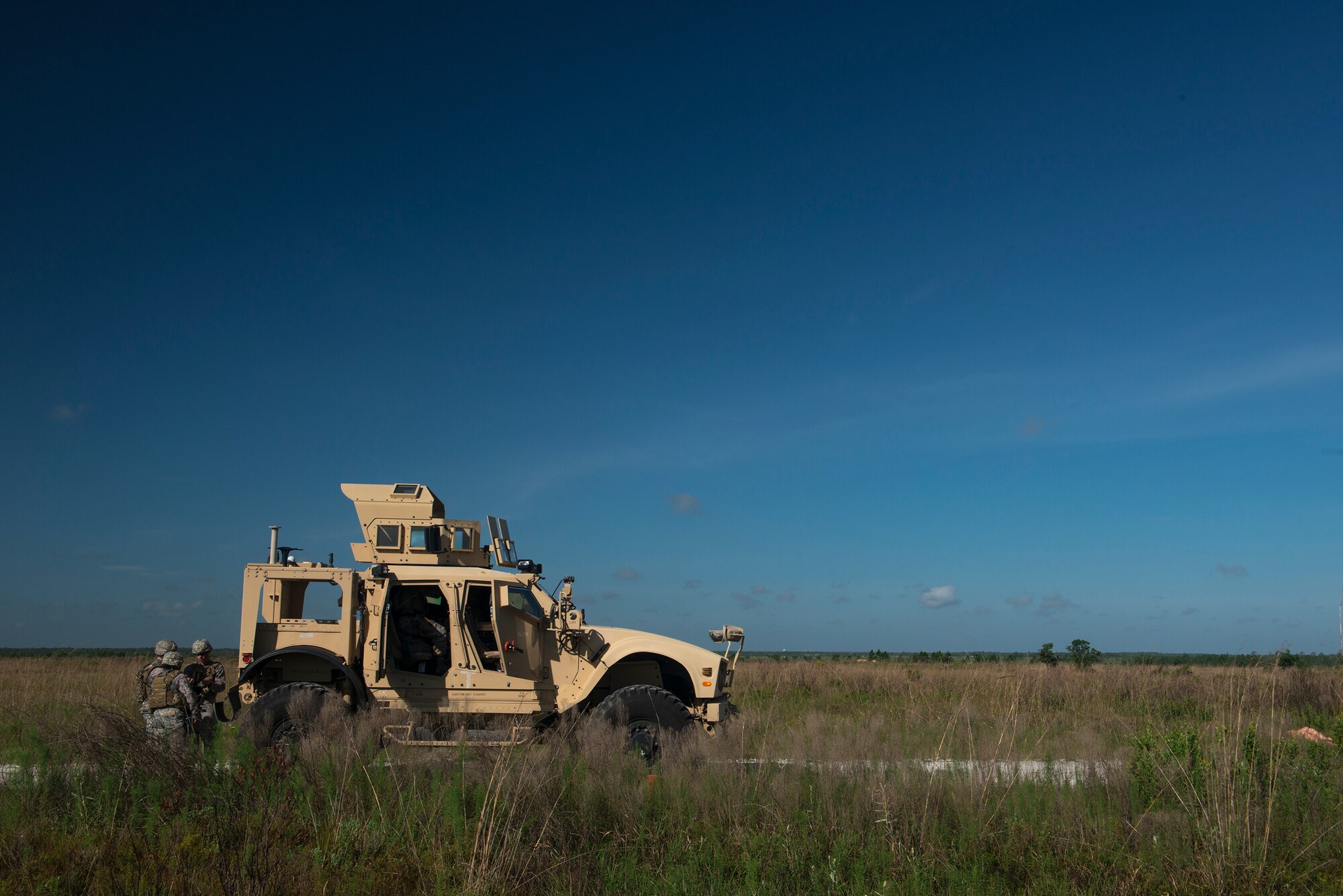 Airmen from the 820th Base Defense Group prepare for a mission behind a mine resistant, ambush-protected vehicle during the functional area event portion of Spartan Warrior May 13, 2015, at Avon Park Air Force Range, Fla. The final day of Spartan Warrior was different for each of the three battlefield career fields within the 93d Air Ground Operations Wing. (U.S. Air Force photo by Senior Airman Ryan Callaghan/Released)

