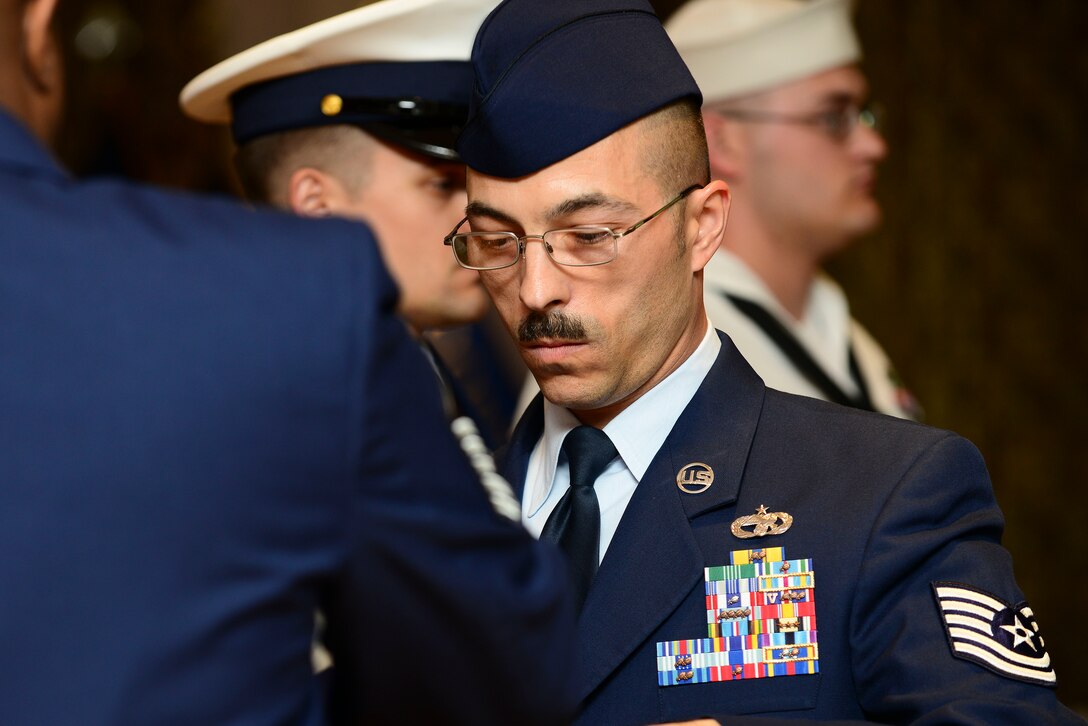 U.S. Air Force Tech Sgt. John Koenig, Joint Task Force Civil Support noncommissioned officer in charge of surface transportation, passes the flag during the 50th Vietnam War Commemoration luncheon at Fort Eustis, Va., May 15, 5015. Koenig and his color guard team were guided along with their flag folding by the spoken word performance of “Old Glory.”  The joint honor guard were in attendance to help honor and celebrate the 50th Anniversary of the Vietnam War. (U.S. Air Force photo by Senior Airman Kimberly Nagle/Released)  