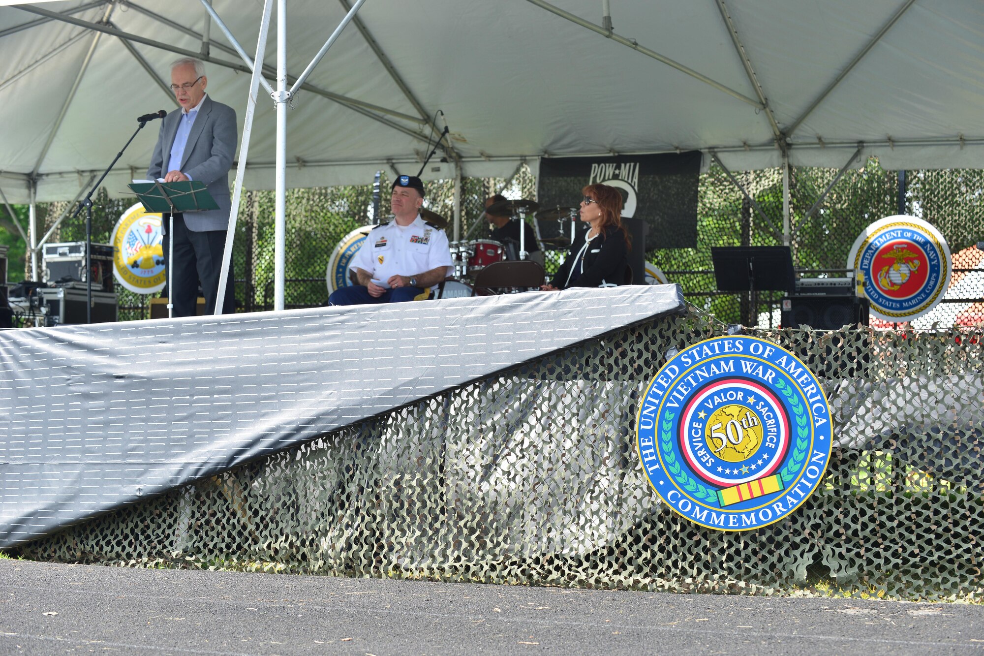 Vietnam Veteran U.S. Air Force Col. (retired) Douglas Webster, left, speaks at the Joint Base Langley-Eustis Vietnam Commemoration opening ceremony at Fort Eustis, Va., May 16, 2015. Webster was a C-130 navigator who survived an engine malfunctioning while in flight during the Vietnam conflict. (U.S. Air Force photo by Staff Sgt. Natasha Stannard/Released) 