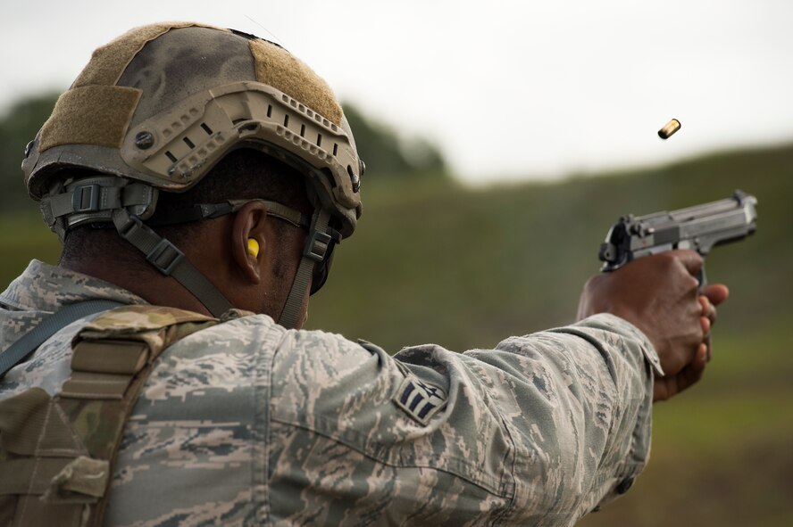 U.S. Air Force Senior Airman Tyrone Stainback, 14th Air Support Operations Squadron joint terminal air controller, fires an M9 Beretta pistol during Spartan Warrior May 12, 2015, at Avon Park Air Force Range, Fla. In addition to the M9, competitors also had to fire the M4 Carbine with and without gas masks. (U.S. Air Force photo by Senior Airman Ryan Callaghan/Released)