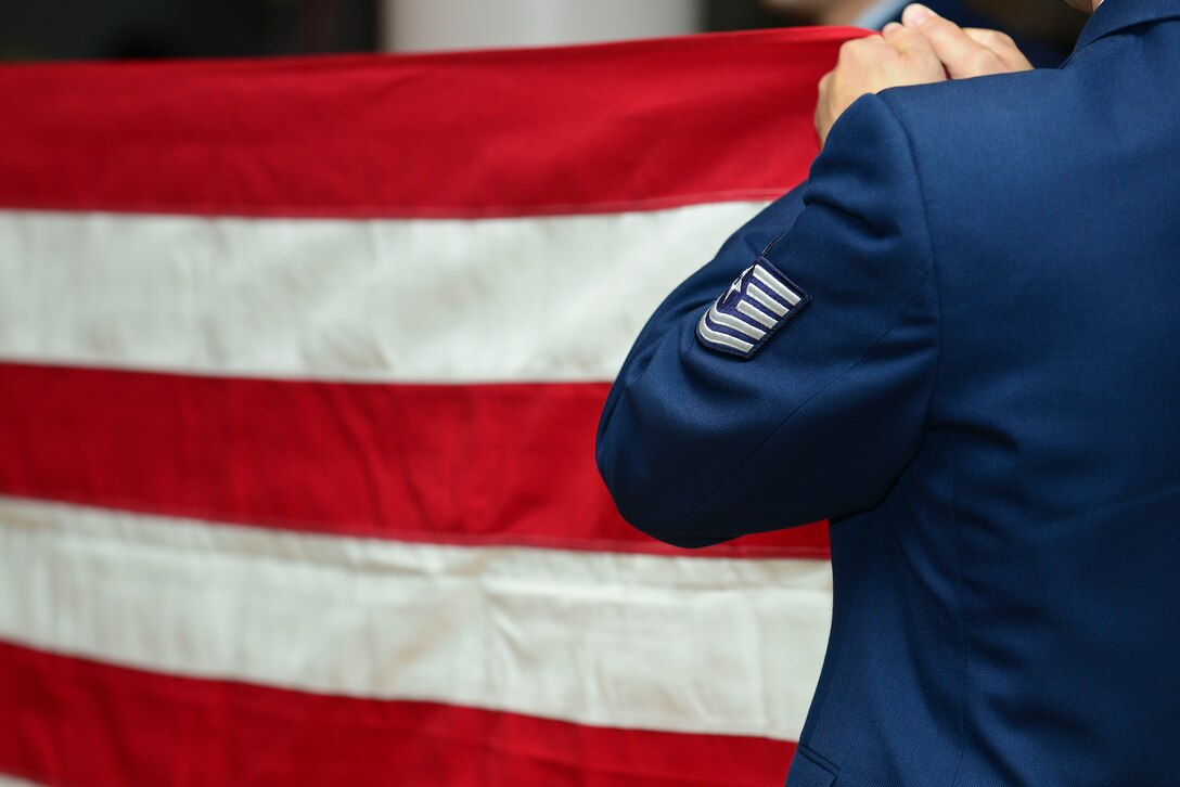 U.S. Air Force Tech Sgt. John Koenig, Joint Task Force Civil Support noncommissioned officer in charge of surface transportation, takes part in a flag folding ceremony during the 50th Vietnam War Commemoration luncheon at Fort Eustis, Va., May 15, 2015. The flag was folded as U.S. Air Force Retired Chief Master Sgt. Deborah Rothwell performed a rendition of “Old Glory”. While Rothwell recited “Old Glory,” the flag folding followed along with her ceremonially.  (U.S. Air Force photo by Senior Airman Kimberly Nagle/Released)  