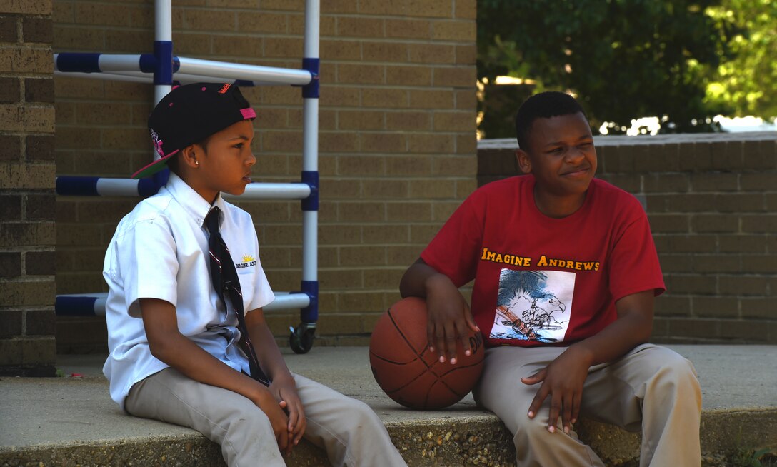 Children rest between basketball games at the Joint Base Andrews Youth Center during an after-school program, May 15, 2015. Sign-up for Summer Day Camp is online at www.andrewsfss.com/youth; for more information call the Joint Base Andrews Youth Center at 981-5430. (U.S. Air Force photo by Senior Airman Haddenham/Released)